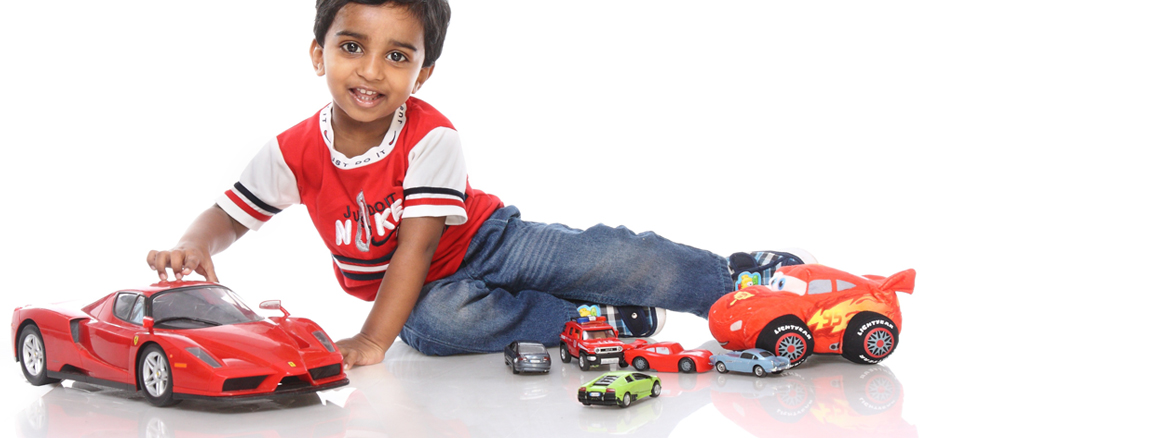 Child playing with toy cars